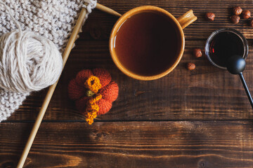 Wood background with knitted accessories, top view