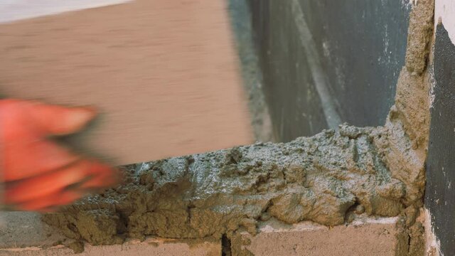 Construction work. Cinder block laying. Work of masons.