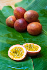Ripe passion fruit, on a wet banana leaf. Vitamins, fruits, healthy foods