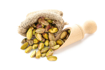 Tasty pistachios in sack and scoop on white background