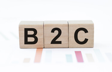 Business Acronym, B2C Text on Wooden Cubes on Table with Color Graphs