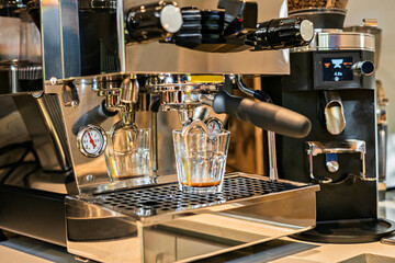 Stylish metallic coffee espresso making machine brewing cup of coffee
