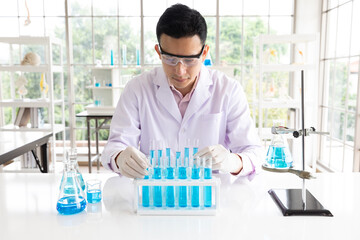 scientist man doing or testing a chemical experiment in laboratory