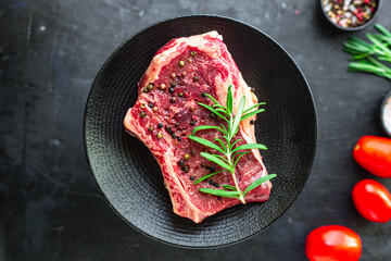 Fototapeta na wymiar raw steak rib eye meat beef juicy on the table serving size second course top view copy space for text food background rustic