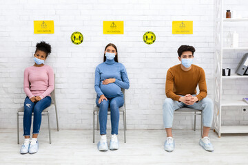 Multiracial People Waiting For Covid-19 Vaccination Sitting In Clinic