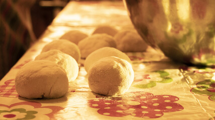 raw balls of bread in the kitchen table on sunshine light 