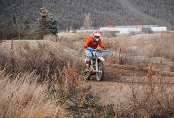 Racing rider on a motorcycle on a road in nature; Czech Republic