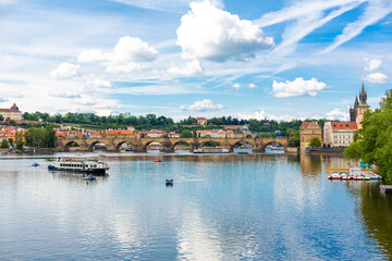 Fototapeta na wymiar The landscape of the city of Prague view from the Vltava river on the ancient architecture of the city