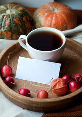 Autumn still life with coffee, note, pumpkin, physalis and small red apples