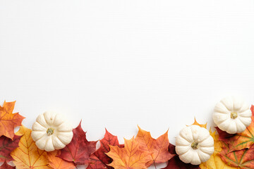 Autumn composition. Frame made of fallen leaves and pumpkins on white background. Flat lay, top view. Hygge style, autumn fall concept.