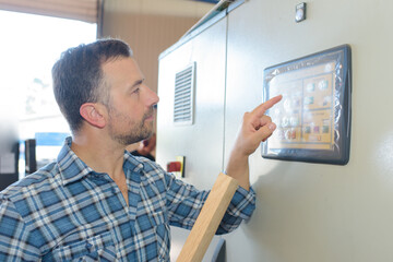 Fototapeta premium a man changing the machine setting