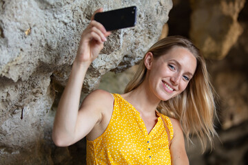 tourist woman taking pictures on a cave