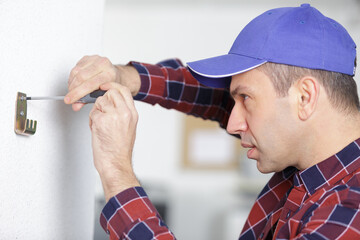 a man is installing a hook