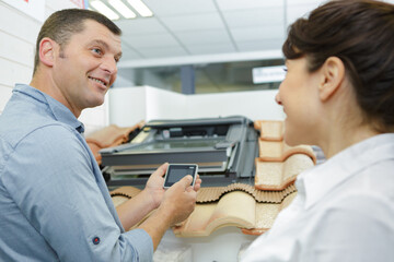 salesman showing rooflight controller to interested client