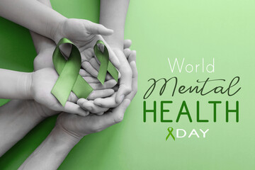 Adult and child hands holding Green Ribbon, World Mental Health Day