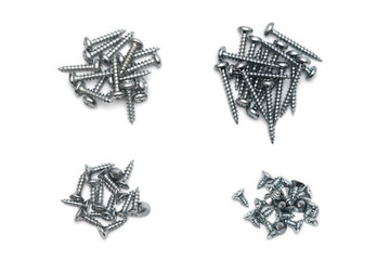 Various type of wood screws gathered in four piles isolated on white background. Fly cut wood...