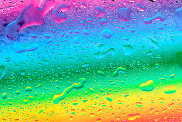 water drops on rainbow background
Rainbow background (texture) with water droplets of different shapes, top view close-up.