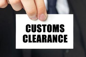 Businessman shows a card with the text - CUSTOMS CLEARANCE