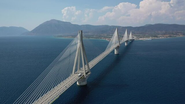 Aerial drone video of cable suspension bridge of Rio - Antirio crossing Corinthian Gulf, mainland Greece to Peloponnese, Patras, Greece