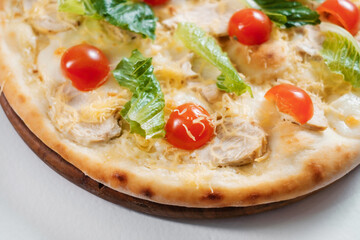 Italian pizza mixed with caesar salad. Cooking concept in the style of Italian cuisine.