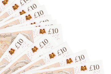 10 British pounds bills lies isolated on white background with copy space stacked in fan close up