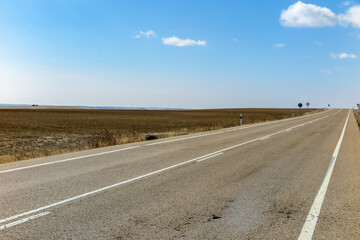 Long road in a flat and dry place between the cities of Burgos and Leon, province of Leon, autonomous community of Castile and Leon, Spain