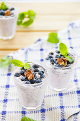  Juicy and fresh blueberries with green leaves. Creative atmospheric decoration