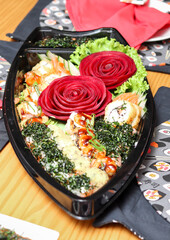 Japanese dinner with sushi, sashimi and shimeji in a boat