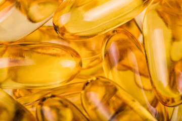 Extreme close up of fish oil orange yellow softgels capsules fish oil omega 3 or omega 6, omega 9,...