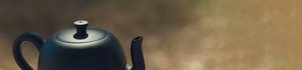 Chinese tea ceremony. Ceramic teapot made of clay and bowls on a wooden background.