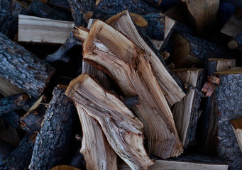 chipped firewood of various shapes lie chaotically on a heap