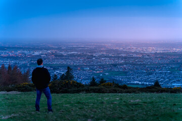 Fototapeta premium Defocused man silhouette watching how twilight begins yielding to daylight at Dublin city