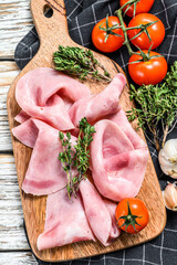 Sliced ham. Fresh prosciutto. Pork ham sliced. White wooden background. Top view