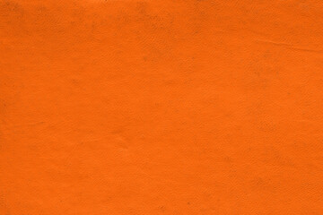 Naklejka premium Vintage and old looking paper background. Colored orange with a brown retro book cover. Ancient book page.
