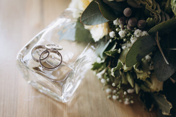 Wedding rings of the bride and groom are in a glass box on the succulent, the box is on the table in the bride's room
