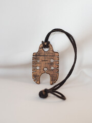 wooden amulet around the neck