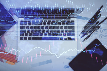 Multi exposure of forex chart drawing over table background with computer. Concept of financial research and analysis. Top view.