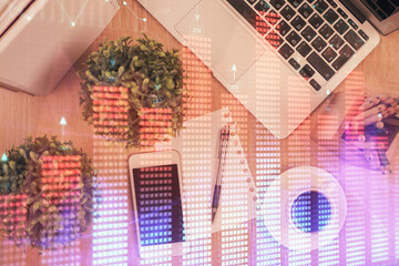 Multi exposure of financial chart hologram over desktop with phone. Top view. Mobile trade platform concept.