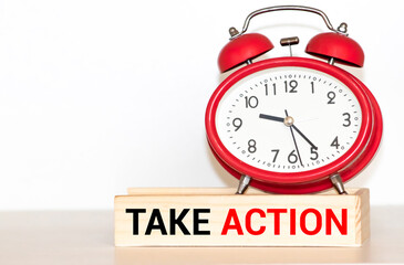 Take action now words written on wooden table with clock,dice,calculator pen and compass