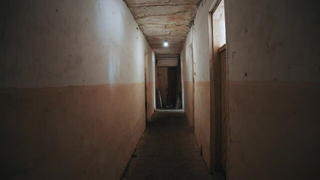 Walking in old destructed hallway of hospital or hotel. Abandoned building. Pov shot, tracking motion. Interiors. Horror scene.