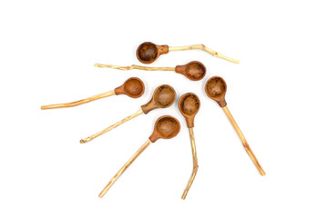 Photo of a ceramic teaspoon with a wooden handle made of twigs