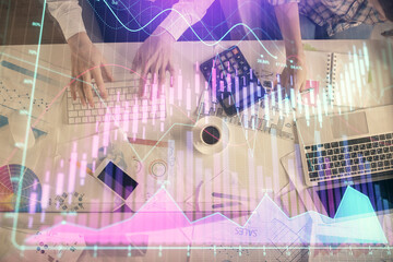 Double exposure of man and woman working together and financial chart hologram drawing. market...