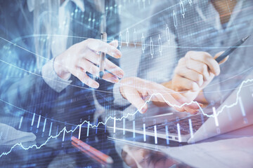 Multi exposure of man and woman working together and financial chart hologram. Business concept. Computer background.