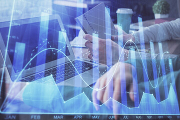 Obraz na płótnie Canvas Double exposure of man and woman working together and forex chart hologram. Business concept. Computer background.