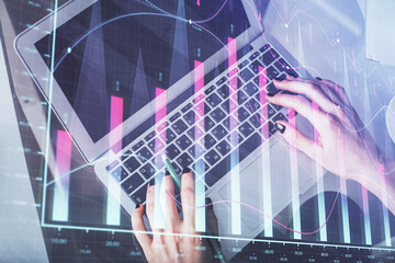 Double exposure of woman hands working on computer and forex chart hologram drawing. Top View. Financial analysis concept.