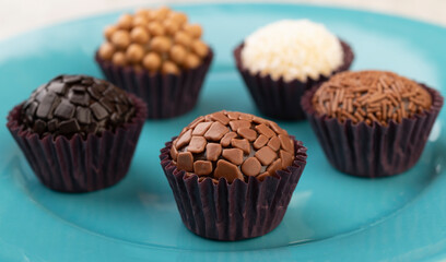 Typical brazilian brigadeiros, various flavors on a blue dish