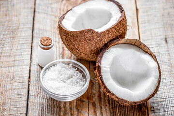 organic cosmetics with coconut on wooden background
