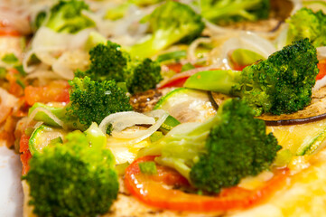 Vegetarian Pizza, with tomato sauce, broccoli, tomatoes, zucchini, eggplant and onion rings
