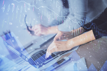 Fototapeta premium Multi exposure of woman hands typing on computer and financial chart hologram drawing. Stock market analysis concept.
