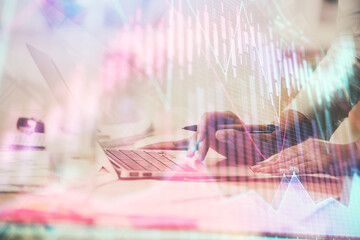 Multi exposure of woman hands typing on computer and financial chart hologram drawing. Stock market analysis concept.